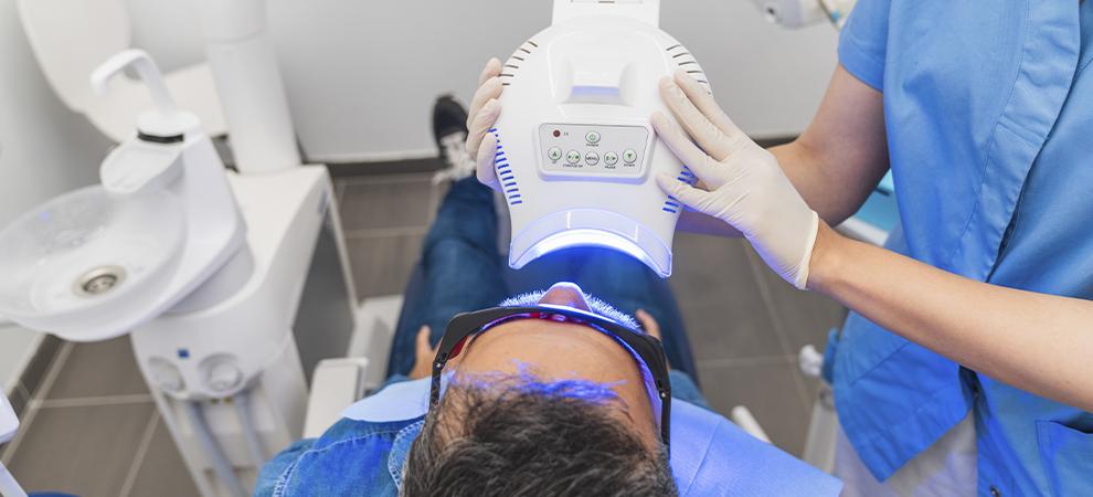 dentista aplicando blanqueamiento dental
